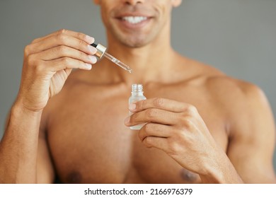 Close Up Of Man Using Face Serum While Taking Care Of His Skin.