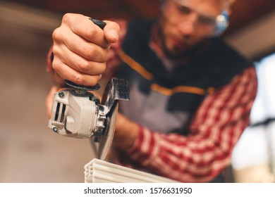Close up of a man using grinder. Selective focus on hand and grinder,