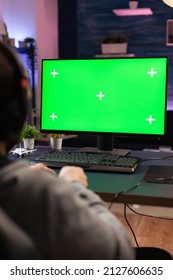 Close Up Of Man Using Horizontal Green Screen On Computer. Adult Playing Video Games On Chroma Key With Isolated Mockup Template And Background On Display. Gamer With Technology And Equipment.