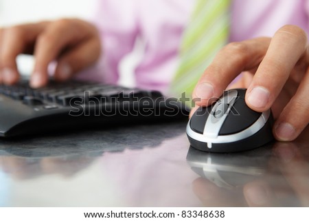 Close up man using  keyboard and mouse
