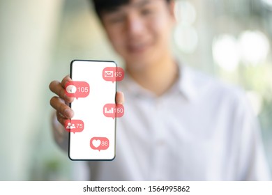 Close up of man using mobile device  with social media internet icons. Modern and smart lifestyle with online mobile technology.  