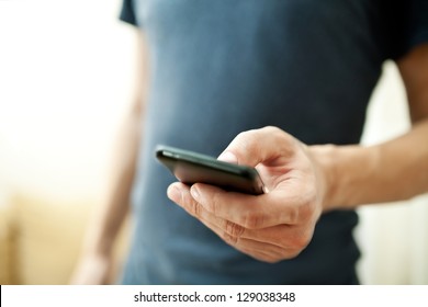 Close up of a man using mobile smart phone - Shutterstock ID 129038348
