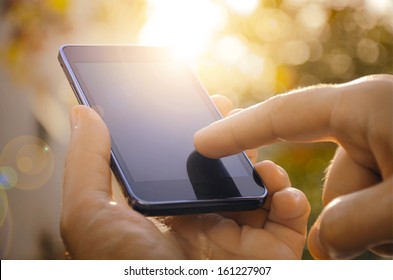 Close up of a man using mobile smart phone outdoor - Shutterstock ID 161227907
