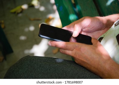 Close up of a man using mobile smart phone