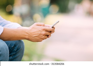 Close Up Of A Man Using Mobile Smart Phone Outside