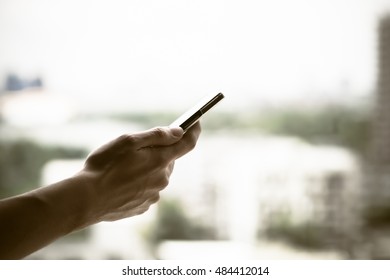 Close up of a man using mobile or smart phone, vintage