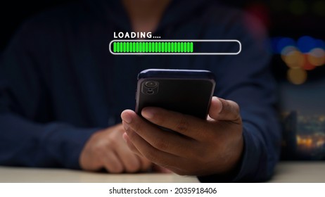 Close up man using mobile smartphone for download application and waiting to loading. loading bar symbol. businessman downloading digital business data form website and cloud to smartphone. - Shutterstock ID 2035918406