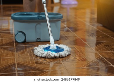 Close up of man using a mop to mop the floor. Concept, chore. Household. Housework. Cleaning house. Housekeeping for sanitary or hygienic. Daily routine lifestyle.                                     