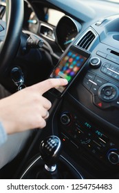 Close up of man using smart phone in the car. Finger on touchscreen. - Shutterstock ID 1254754483
