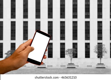 Close Up Of A Man Using Smart Phone With Blank Mobile And Landscape Blur Background.Smart Phone With Blank Screen And Can Be Add Your Texts Or Others On Smart Phone..
