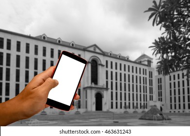 Close Up Of A Man Using Smart Phone With Blank Mobile And Landscape Blur Background.Smart Phone With Blank Screen And Can Be Add Your Texts Or Others On Smart Phone..
