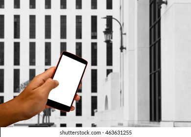 Close Up Of A Man Using Smart Phone With Blank Mobile And Landscape Blur Background.Smart Phone With Blank Screen And Can Be Add Your Texts Or Others On Smart Phone..
