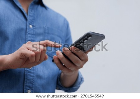 Close up man using smart phone mobile device for play or shopping online or check time and date , teenager with technology and social distance concept