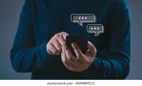 Close up of man using smartphone with chat message icons, concept of online communication, mobile messaging, digital technology, social networking, instant chat apps, and modern lifestyle connection.