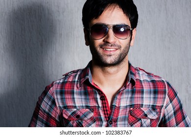 Close Up Of A Man Wearing Sunglasses Against A Grey Wall, Close Up Of A Happy Man Wearing Sunglasses