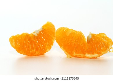 Close up of mandarin orange pulps on white background - Shutterstock ID 2111175845