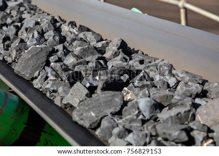 Close up of Manganese ore on a conveyor belt