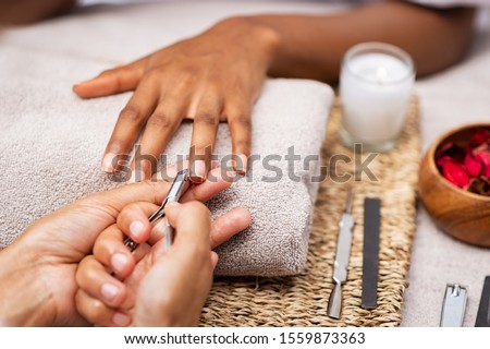 Similar – Woman filing nails in colored background