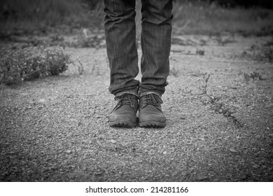 Close up of man's boots while hiking on trail in the mountains.