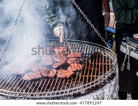Close up of a man's hand preparing bbq during the summer party