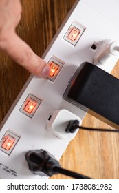 Close Up A Mans Hand Turn On The Switch On Power Strip.