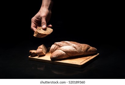 Close Up Of Mans Hands Holding The Baguette