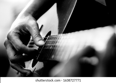 Close Up Of Man's Hands Playing Acoustic Guitar. Musical Instrument For Recreation Or Hobby Passion Concept.
