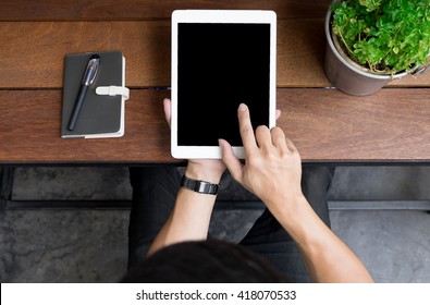 Close up of mans hands using tablet on counter, Image taken from above