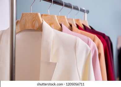 Close Up Of Many Colors Of Fashionable Business Suits Hanging On Rack For Sale In Store