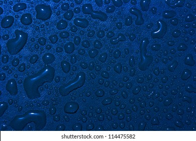 A Close Up Of Many Dark Blue Water Drops