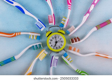 A close up of many different types of toothbrushes.Colored toothbrushes on a color background. Dental health and hygiene concept.Concept of variety and choice when it comes to oral hygiene products. 