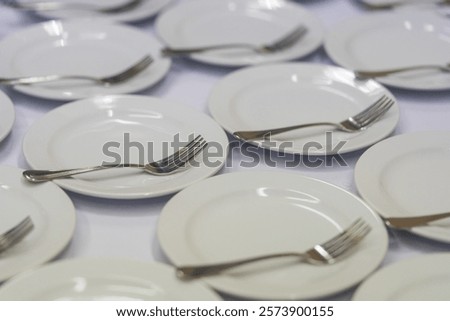 Close up of many empty clean small plates and fork for coffee or tea and desserts in hotel or restaurant. Coffee brake in office.