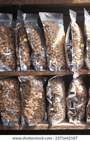 close up of many mixed nuts in packet at shelf 