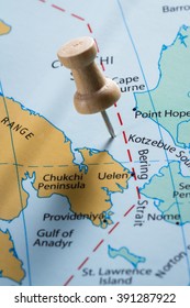 Close Up Of  Map With The Words Bering Sea In Focus With A Push Pin Marking The Spot