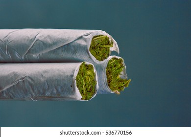 Close Up Of Marijuana Cigarette On Black Background