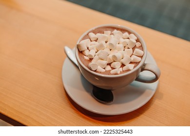 Close up marshmallow with milk coffee cacao or latte. Hot aromatic chocolate beverage in white ceramic mug. Warming snack food in street cafe. Winter drink

 - Powered by Shutterstock