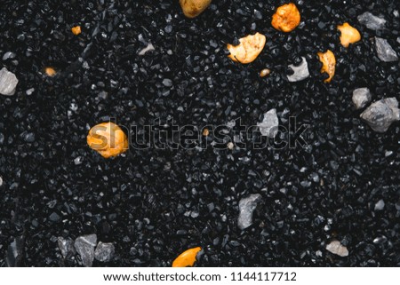 Close up mass of small black and big yellow stone using as background