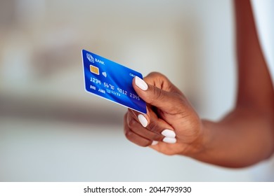 Close Up Of Mature African Woman Holding Bank Credit Card To Make A Payment.  Woman Hand Holding Credit Card For Financial Transaction Or Contact Less Payment.