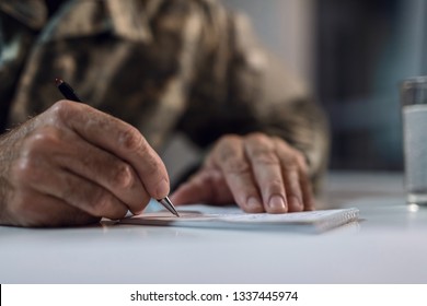 Close Up Of Mature Army Soldier Writing A Letter. 