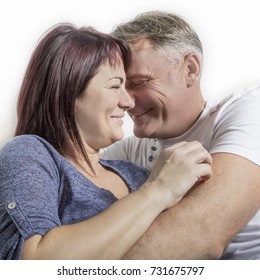 Close Up Of A Mature Embracing  And Smiling Couple With Laugh Lines On The Faces