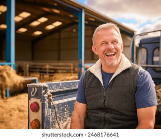 Close Up Of Mature Male Farm Worker Sitting On Tailgate Of Off Road Farm Vehicle - Powered by Shutterstock