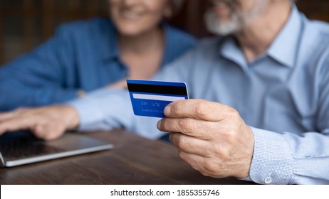 Close Up Mature Man Holding Plastic Credit Card, Senior Couple Family Paying Online, Using Laptop, Satisfied Older Customers Making Secure Internet Payment, Shopping, Browsing Banking Service