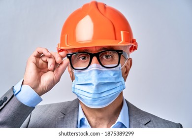 Close up of mature man wearing a protective mask and adjusting glasses, isolated on blue background. Protection and safety concept - Powered by Shutterstock