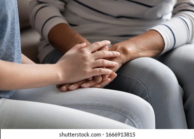 Close Up Of Mature Mom And Adult Daughter Hold Hands Sharing Secrets Having Close Intimate Family Moment Together, Loving Senior Mother And Grownup Girl Child Talk Show Care And Understanding