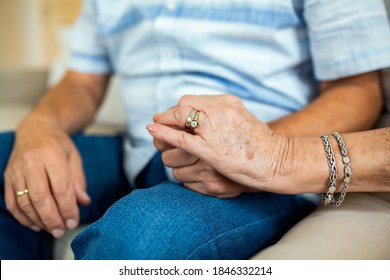 Close Up Of Mature Old Husband And Wife Hold Hands Show Love And Care. Senior Couple Holding Hands While Sitting Together At Home. Elderly Relationships, Marriage Concept