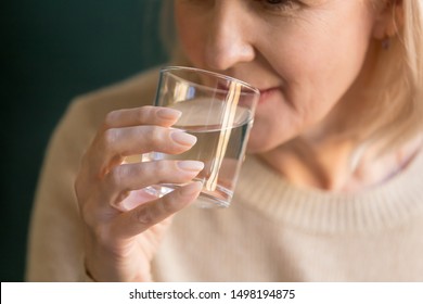 Close Up Of Mature Old Lady Hold Glass Drinking Pure Mineral Still Filtered Water For Body Balance, Elderly Woman Take Care Of Health Enjoy Clean Aqua Recommend Dieting, Healthy Lifestyle Concept