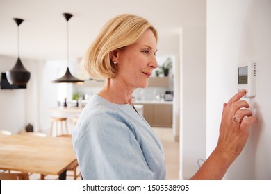 Close Up Of Mature Woman Adjusting Central Heating Temperature At Home On Thermostat - Shutterstock ID 1505538905