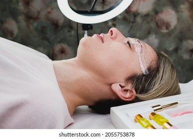 Close Up Of A Mature Woman Getting Eyebrow Lamination Procedure  At The Beauty Salon.