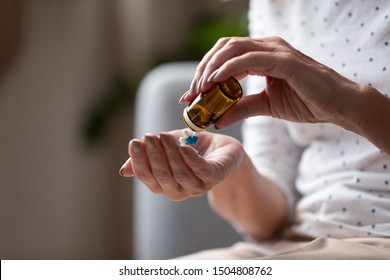Close up mature woman taking out pills from bottle, supplements or antibiotic, older female preparing to take emergency medicine, chronic disease, healthcare and treatment concept - Shutterstock ID 1504808762
