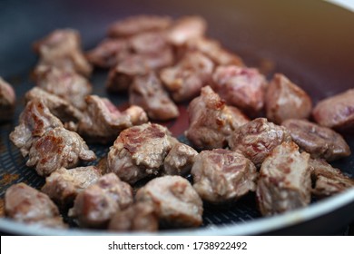Close up of meat beef cubes chunks in a frying pan. Preparing dinner concept